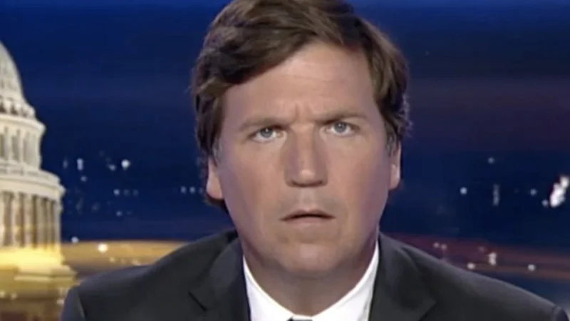 Tucker Carlson close-up on Fox News set with Capitol dome in background