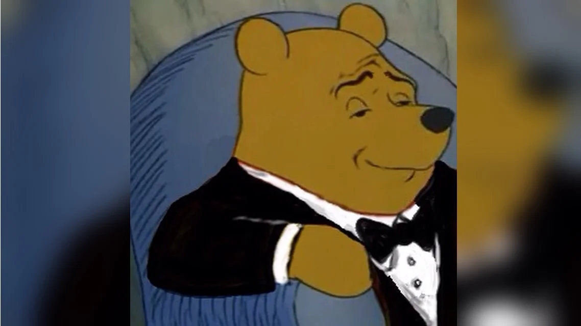 Tuxedo Winnie Pooh — Slightly out-of-focus tuxedo Winnie in formal black attire.