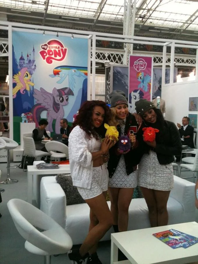 Twilight Sparkle Alicorn Controversy — Three women posing in front of My Little Pony booth showing Twilight as alicorn