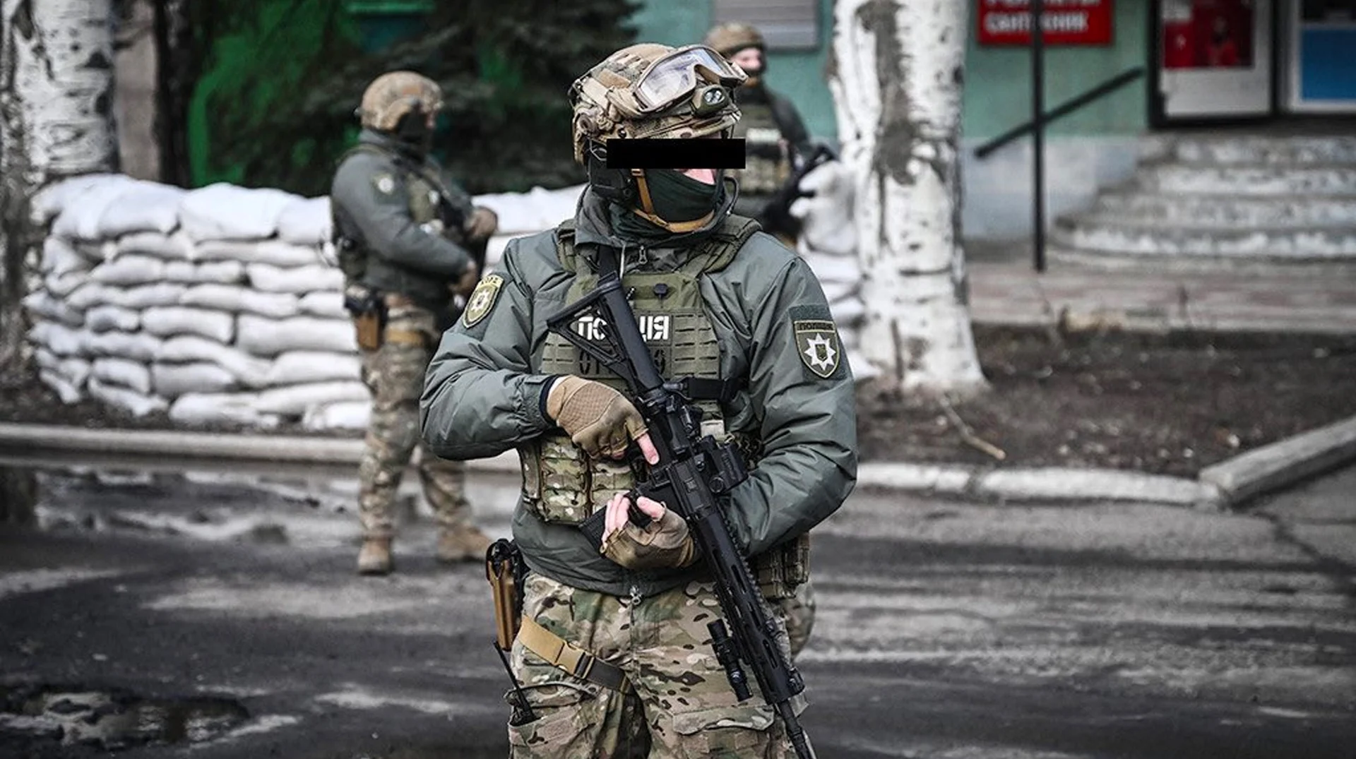 Ukrainian Reaper — Armed Ukrainian soldier in tactical gear with blacked-out eyes holding a rifle near sandbag barricades