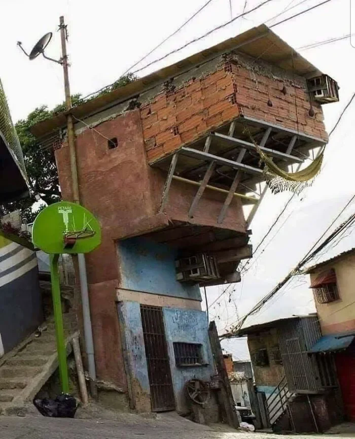 Unhinged Home Design — Brick building constructed in inverted orientation with downward elements.