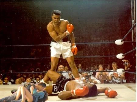 Vancouver Riot Kiss — Couple replacing Liston under triumphant Muhammad Ali.