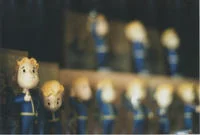 Vault Boy — Dark and out-of-focus photograph with blurred figures.