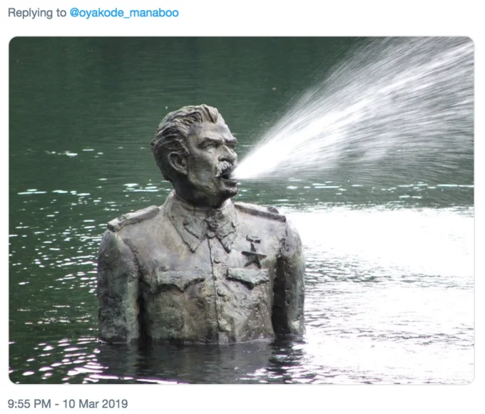 Vomiting Water Puffer Fish — Bronze military statue submerged in water with water spraying from its mouth