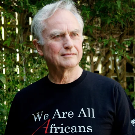 Cropped square photo of Richard Dawkins wearing the 'We Are All Africans' shirt.
