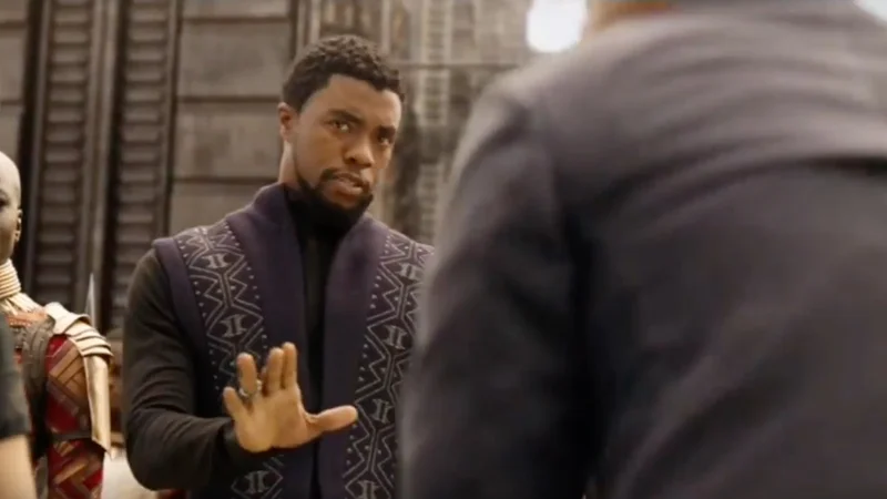 We Don't Do That Here — T'Challa from Black Panther holding up his hand in a disapproving gesture toward a man with his back turned.