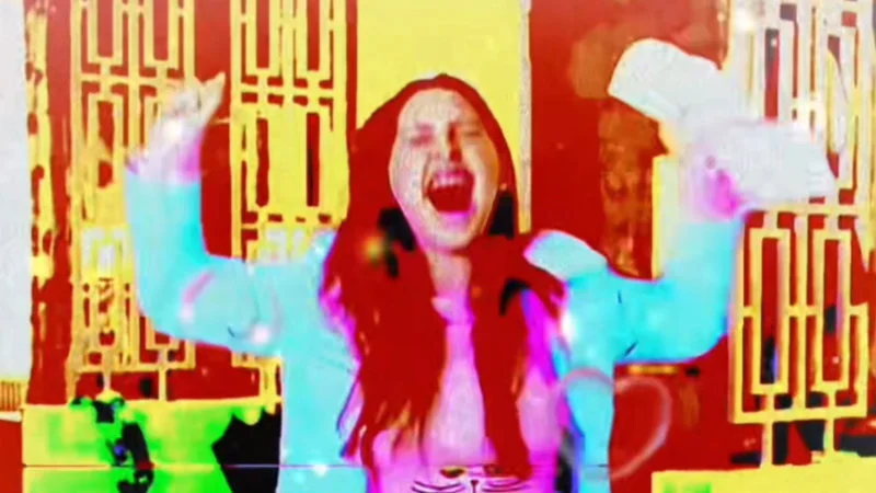 We Just Got 8 Free Pizzas — Overexposed glitch edit of a red-haired woman screaming with arms raised in bright red and cyan colors
