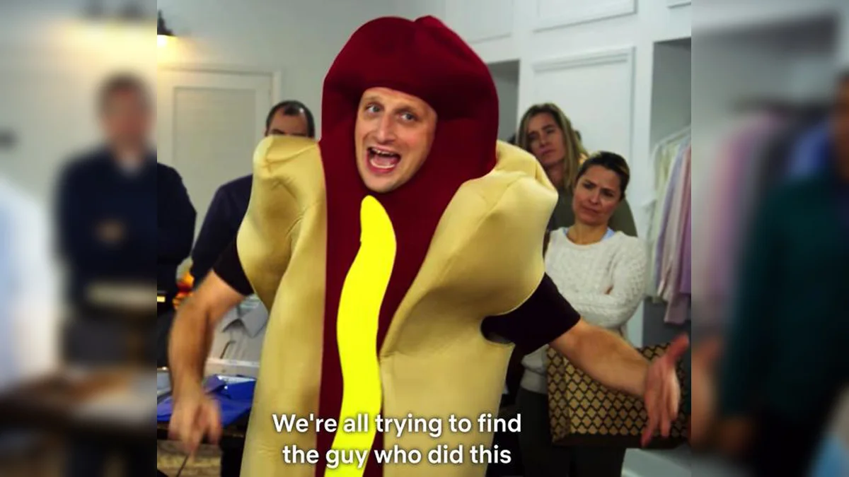Man in a hot dog costume gesturing with the caption 'We're all trying to find the guy who did this'.