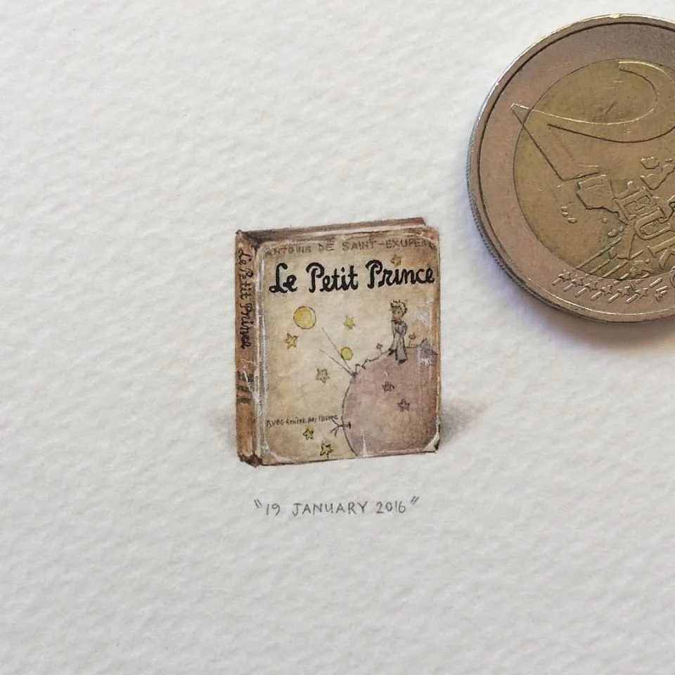 What is This? A Center for Ants? — Miniature watercolor painting of Le Petit Prince book beside a Euro coin