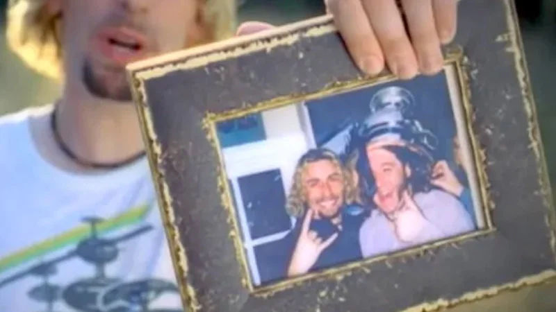 What The Hell Is On Joeys Head — Screenshot from the Nickelback 'Photograph' music video showing a framed photograph held prominently in the shot.