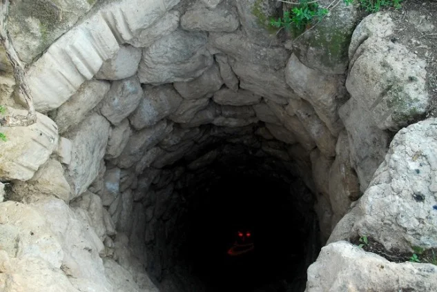 When You See it... — Dark stone well with a red glowing smiley face visible at the bottom