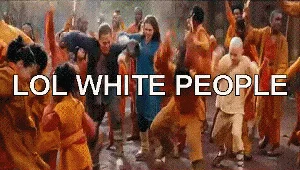 White People Dancing Lol White People — Video still showing a white woman dancing enthusiastically amid a crowd dressed in orange robes with 'LOL WHITE PEOPLE'