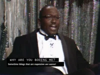 Why Are You Booing Me I'm Right — Creative mashup overlaying animated character onto the meme format with formal man and text.