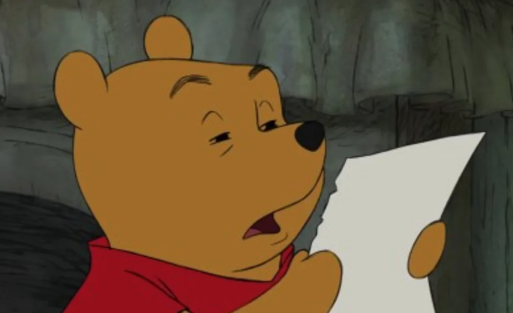 Winnie the Pooh Reading — Winnie the Pooh in red shirt reading a piece of paper with a skeptical expression