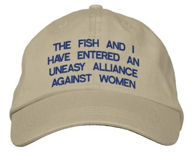 "Women Want Me, Fish Fear Me" Hat Parodies — Video game character wearing a khaki cap embroidered with 'Women Want Me, Fish Fear Me.'