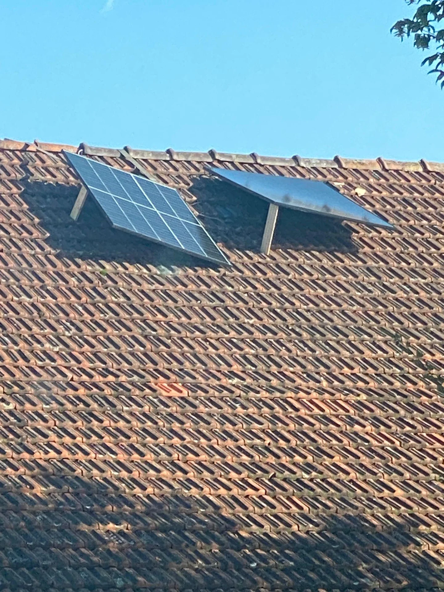 WTF — Solar panels installed inside holes cut into a tile roof