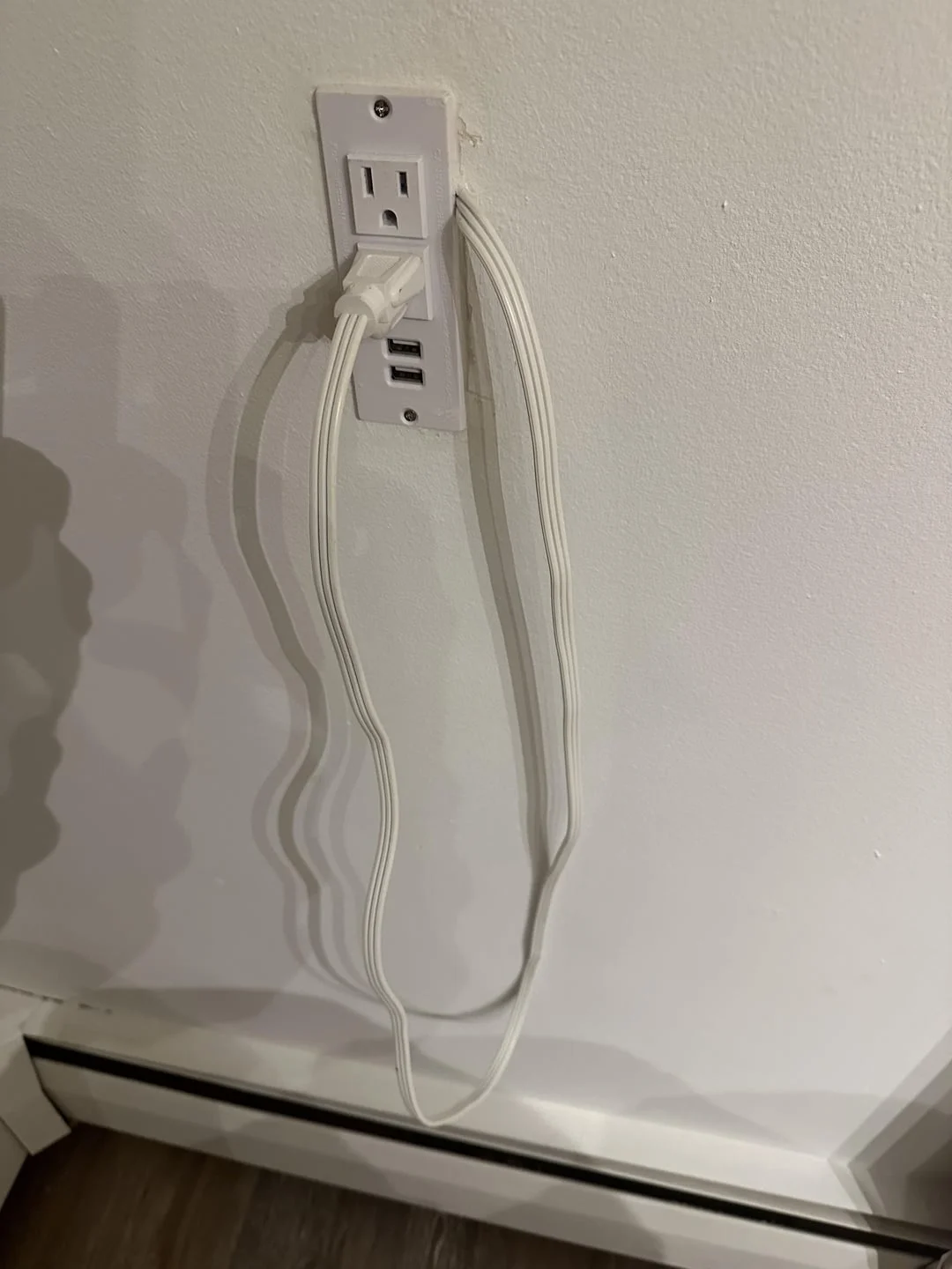 WTF — Oddly configured electrical wall outlet with looped cords