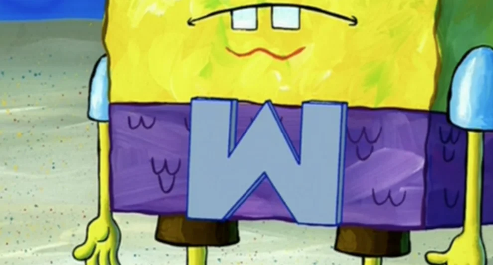 Wumbo — SpongeBob SquarePants holding a large letter W in front of his shorts on the beach.