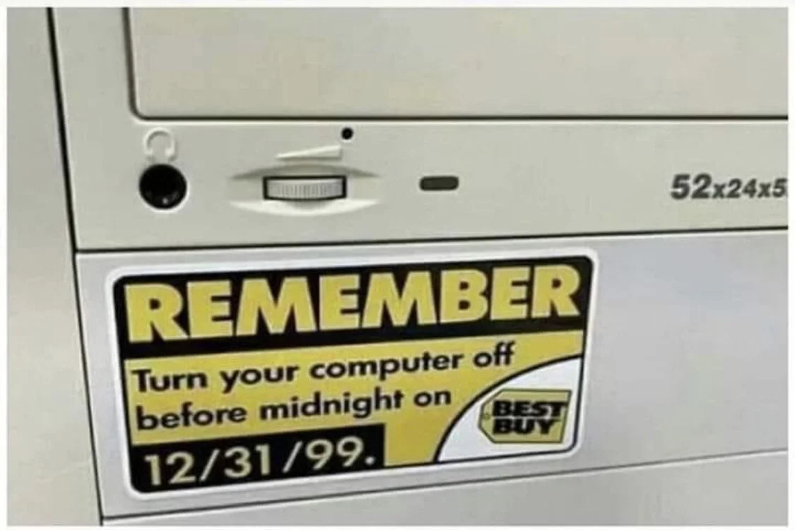 Y2K Bug — Best Buy sticker on a beige PC telling users to turn the computer off before midnight on 12/31/99
