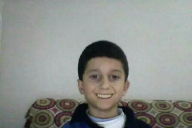 Smiling webcam photo of the Yotube meme boy on his patterned couch