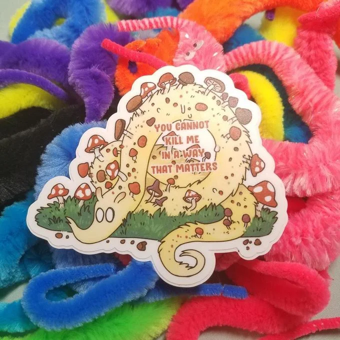 You Cannot Kill Me In A Way That Matters — Vibrant psychedelic-styled fan-created sticker art with colorful mushrooms and phrase.