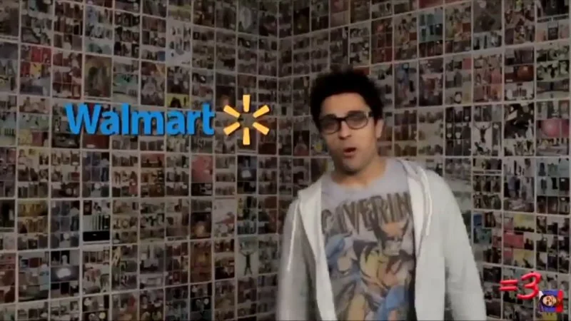 You Guys Ever Been To Walmart — Ray William Johnson wearing glasses and cardigan in front of photo collage wall with Walmart logo.