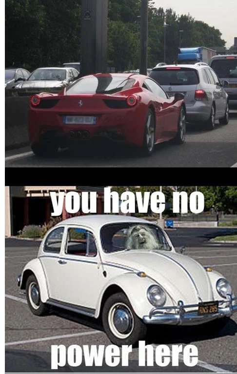 You Have No Power Here! — Ferrari stuck in traffic above VW Beetle with Theoden photoshopped as driver