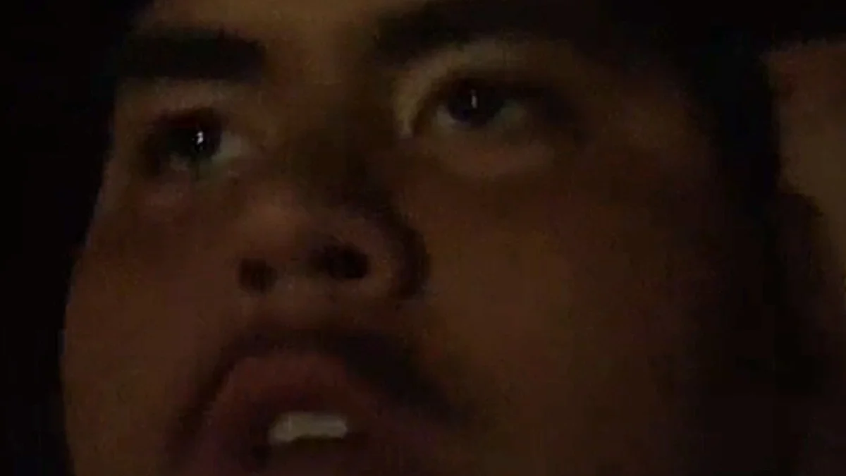 You Keep Saying I Have No Bitches — Dark, grainy close-up of a young man's face at night with his mouth slightly open