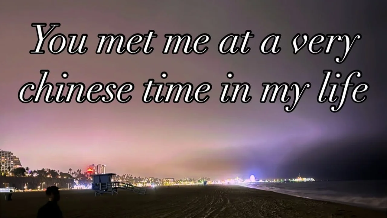 Night beach photo with text 'You met me at a very chinese time in my life' in white italic serif font.