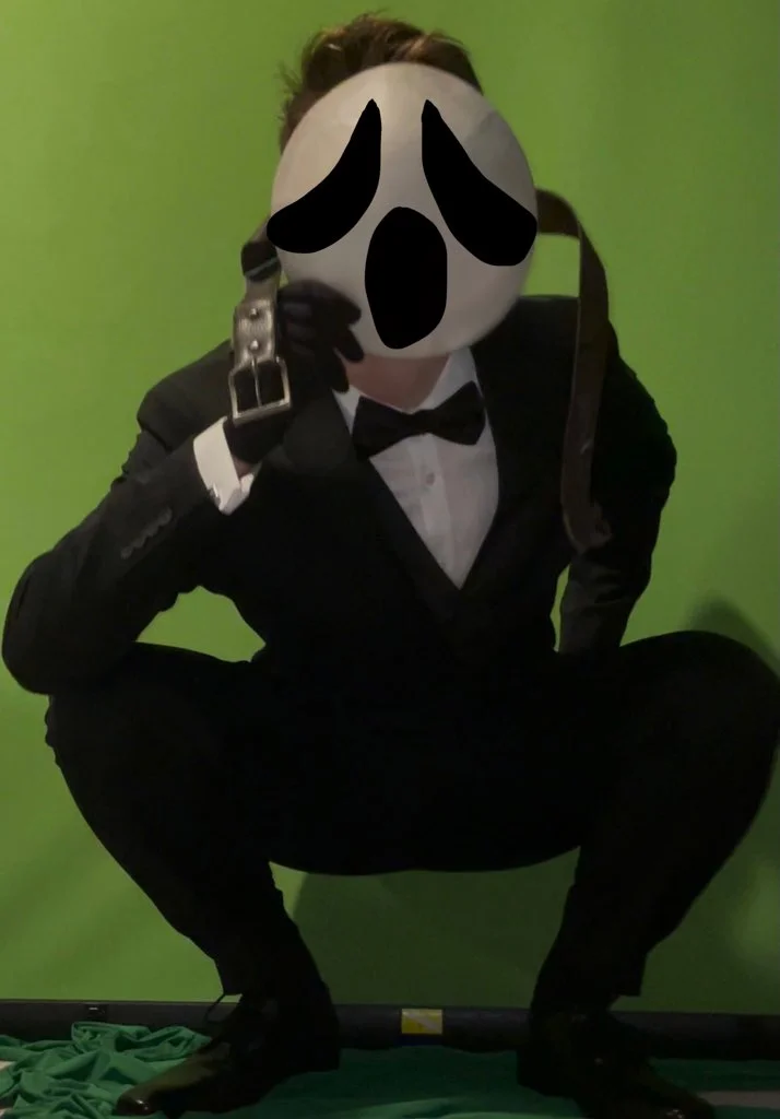 "You Poor Thing" Ghostface Thirst Trap — Person in tuxedo and Ghostface mask squatting against a green background.