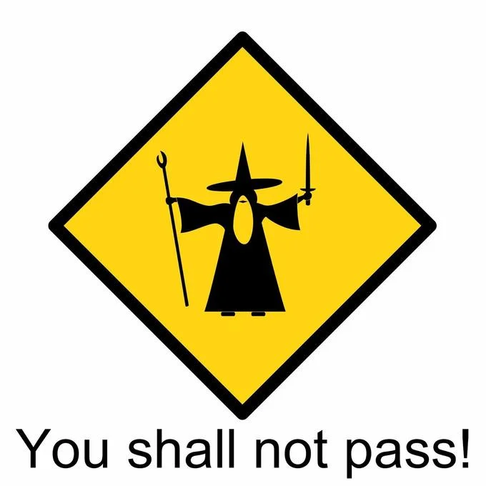 Yellow diamond warning sign with wizard silhouette in defensive pose and 'You shall not pass!'
