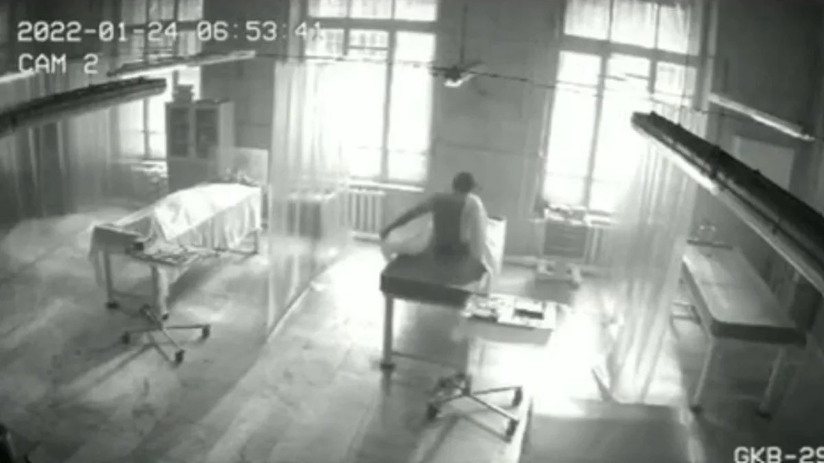 Zombies In China — Black-and-white CCTV footage of a figure sitting upright on a hospital gurney in a dim ward, timestamped January 24 2022.